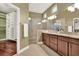 Bathroom with double vanity, granite countertops, and a glass-enclosed shower near a walk-in closet at 1375 Brayford Point, Deland, FL 32724