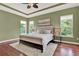 Beautifully decorated bedroom with a plush rug, tray ceiling, and view of the backyard at 1375 Brayford Point, Deland, FL 32724