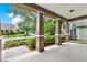 Inviting covered porch with stately columns and meticulously maintained landscaping at 1375 Brayford Point, Deland, FL 32724