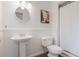 Bathroom featuring a pedestal sink, toilet and shower and bathtub combo, providing a clean and functional design at 1405 Montclair Ct, Orlando, FL 32812