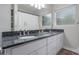 Bathroom featuring a double vanity with a granite countertop, offering a luxurious and functional space at 1405 Montclair Ct, Orlando, FL 32812