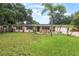 Charming single-story home featuring a well-manicured lawn and decorative palm trees for added curb appeal at 1405 Montclair Ct, Orlando, FL 32812
