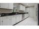 Well-maintained kitchen featuring white cabinets, black granite countertops, and stainless steel appliances at 1405 Montclair Ct, Orlando, FL 32812