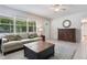 Cozy living room featuring a neutral sofa, tile flooring, and bright natural light from large windows at 1405 Montclair Ct, Orlando, FL 32812