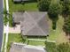 Aerial view showcases the house's roof and lawn with privacy provided by mature trees at 15318 Sandfield Loop, Winter Garden, FL 34787