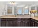 Bright bathroom with granite counters, modern fixtures, dark cabinets and large mirrors at 15318 Sandfield Loop, Winter Garden, FL 34787