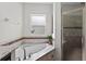 Bathroom showcasing the soaking tub with tile surround and frameless glass shower at 15318 Sandfield Loop, Winter Garden, FL 34787