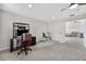 Bedroom featuring a functional desk, a stationary bike, and seamless access to other living spaces at 15318 Sandfield Loop, Winter Garden, FL 34787