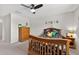 Cozy bedroom with wooden furniture, ceiling fan, carpet, and whimsical wall décor at 15318 Sandfield Loop, Winter Garden, FL 34787