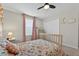 Cozy bedroom with floral bedding, pink curtains, and moon and cloud decorations, perfect for a  at 15318 Sandfield Loop, Winter Garden, FL 34787