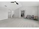 Open bonus room with neutral carpet and walls, featuring an arched doorway and easy access to other rooms at 15318 Sandfield Loop, Winter Garden, FL 34787