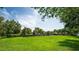 Expansive green area with fenced-in playground, perfect for community gatherings and outdoor activities at 15318 Sandfield Loop, Winter Garden, FL 34787