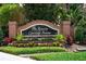 The Reserve at Carriage Pointe community sign amidst lush greenery at 15318 Sandfield Loop, Winter Garden, FL 34787