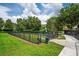 The fenced dog park features lush grass and a convenient waste station for a clean and enjoyable experience at 15318 Sandfield Loop, Winter Garden, FL 34787