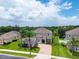 Stunning two-story home with a beautifully landscaped yard, brick driveway, and a welcoming entrance at 15318 Sandfield Loop, Winter Garden, FL 34787