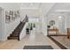 Bright foyer with soaring ceilings, tile floors, staircase, and views of the living areas at 15318 Sandfield Loop, Winter Garden, FL 34787