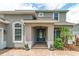 Charming two-story home featuring a welcoming front entrance with manicured landscaping and a beautiful blue front door at 15318 Sandfield Loop, Winter Garden, FL 34787