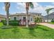 This beautiful home boasts lush landscaping, green grass, and decorative plantings at 15318 Sandfield Loop, Winter Garden, FL 34787