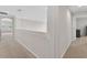 Hallway featuring carpeted floors, recessed lighting, and a view to a window at 15318 Sandfield Loop, Winter Garden, FL 34787