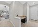 Hallway featuring a granite countertop desk, leading to an open living area at 15318 Sandfield Loop, Winter Garden, FL 34787