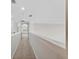 Hallway featuring a carpeted floor, white walls, recessed lighting, and an arched doorway at 15318 Sandfield Loop, Winter Garden, FL 34787