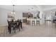 Kitchen and dining area featuring pendant lighting, counter seating, stainless appliances, and a dark wood dining table at 15318 Sandfield Loop, Winter Garden, FL 34787
