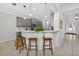 Kitchen with white countertop seating, grey cabinetry, tile floors, and modern lighting at 15318 Sandfield Loop, Winter Garden, FL 34787