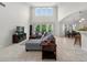 Bright open concept living room with high ceilings, tile floors, and views of the backyard at 15318 Sandfield Loop, Winter Garden, FL 34787