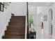 Elegant staircase leading to the upper level of the home, with views of the open floor plan at 15318 Sandfield Loop, Winter Garden, FL 34787