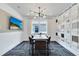 Modern dining room with stylish lighting, a sleek table, and a feature wall of design samples at 1549 Timber Leaf Rd, St Cloud, FL 34771