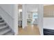 Living room showing stairs, powder room and view of the gathering room at 1549 Timber Leaf Rd, St Cloud, FL 34771