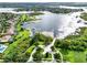 An expansive aerial view of a residential area, showcasing homes, a lake, green spaces, and a community pool at 15613 Camp Dubois Cres, Winter Garden, FL 34787