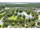 Aerial view showcasing a serene neighborhood pond with green space and walking paths, ideal for outdoor enjoyment at 15613 Camp Dubois Cres, Winter Garden, FL 34787
