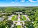 Beautiful aerial view of community entrance showcasing the lush landscaping and surrounding trees at 15613 Camp Dubois Cres, Winter Garden, FL 34787