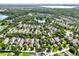 A scenic aerial view of a community featuring well-maintained homes surrounded by mature trees and picturesque lakes at 15613 Camp Dubois Cres, Winter Garden, FL 34787