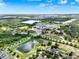 An aerial perspective of a mixed-use development featuring schools, residential areas, and natural landscape with ponds and lakes at 15613 Camp Dubois Cres, Winter Garden, FL 34787