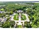 Beautiful aerial view of community entrance showcasing the lush landscaping and surrounding trees at 15613 Camp Dubois Cres, Winter Garden, FL 34787