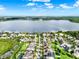 An aerial view of a residential community featuring waterfront property and many green trees at 15613 Camp Dubois Cres, Winter Garden, FL 34787