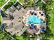 Aerial view of the community pool featuring lounge chairs, tables and many umbrellas for shade at 15613 Camp Dubois Cres, Winter Garden, FL 34787