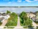 Gorgeous aerial view of homes with lake access and private docks in a lush tropical setting at 15613 Camp Dubois Cres, Winter Garden, FL 34787
