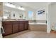 Bright bathroom with a double sink vanity and a tiled corner bathtub at 15613 Camp Dubois Cres, Winter Garden, FL 34787