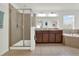 Bright bathroom featuring a glass shower and a double sink vanity at 15613 Camp Dubois Cres, Winter Garden, FL 34787