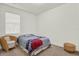 Cozy bedroom features a queen bed with a floral duvet, neutral walls and carpet, and rattan furniture at 15613 Camp Dubois Cres, Winter Garden, FL 34787