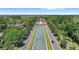An aerial view highlights the community's central water feature and beautifully landscaped entrance with blue sky at 15613 Camp Dubois Cres, Winter Garden, FL 34787