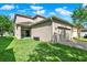 Home with a sliding glass door, lush green lawn, and well maintained landscaping at 15613 Camp Dubois Cres, Winter Garden, FL 34787