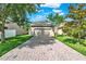 Charming home with a brick driveway, lush green lawn, and mature trees at 15613 Camp Dubois Cres, Winter Garden, FL 34787