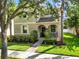 Attractive two-story home with a welcoming front porch and lush landscaping at 15613 Camp Dubois Cres, Winter Garden, FL 34787