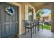 Cozy front porch with seating, a decorative wreath, and a view of the neighborhood at 15613 Camp Dubois Cres, Winter Garden, FL 34787