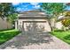 A spacious two-car garage and brick driveway at 15613 Camp Dubois Cres, Winter Garden, FL 34787