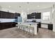 Gourmet kitchen featuring a center island with seating, granite countertops, and stainless appliances at 15613 Camp Dubois Cres, Winter Garden, FL 34787